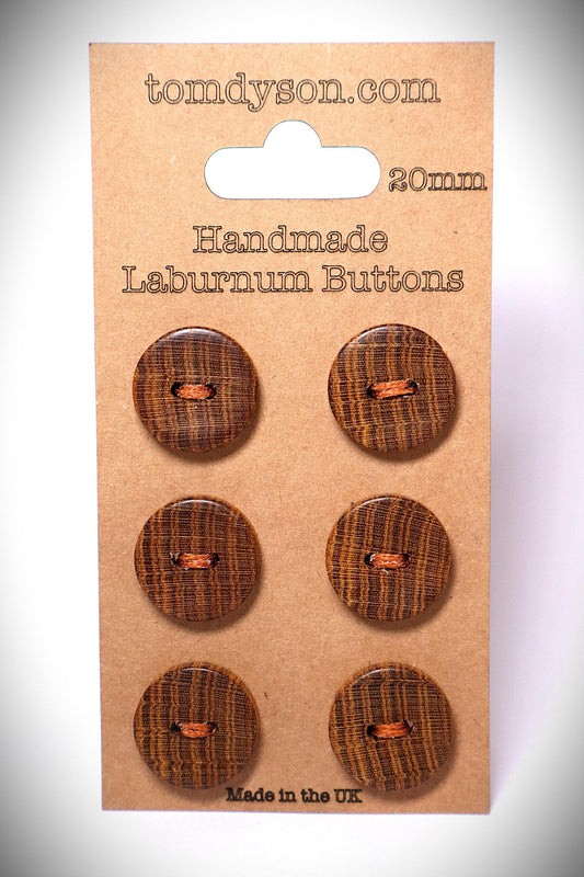 Laburnum 20mm handmade wood buttons. 6 buttons stitched onto a clean brown card. They are brown, with golden growth rings. They are very unique buttons made by Tom Dyson Woodworking. These buttons have 2 holes.