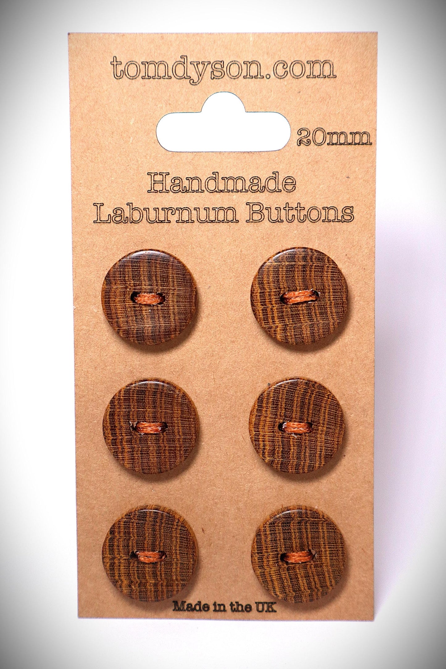 Laburnum  20mm handmade wood buttons. 6 buttons stitched onto a clean brown card. They are brown, with golden growth rings. They are very unique buttons made by Tom Dyson Woodworking. These buttons have 2 holes.